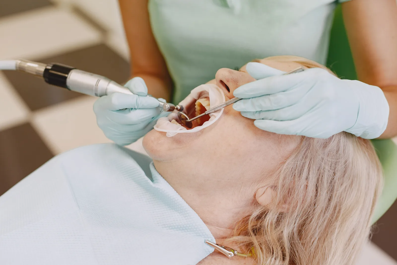 Tooth prepared for a crown with a dental handpiece, shown while covering Implant Lifespan in Winnipeg