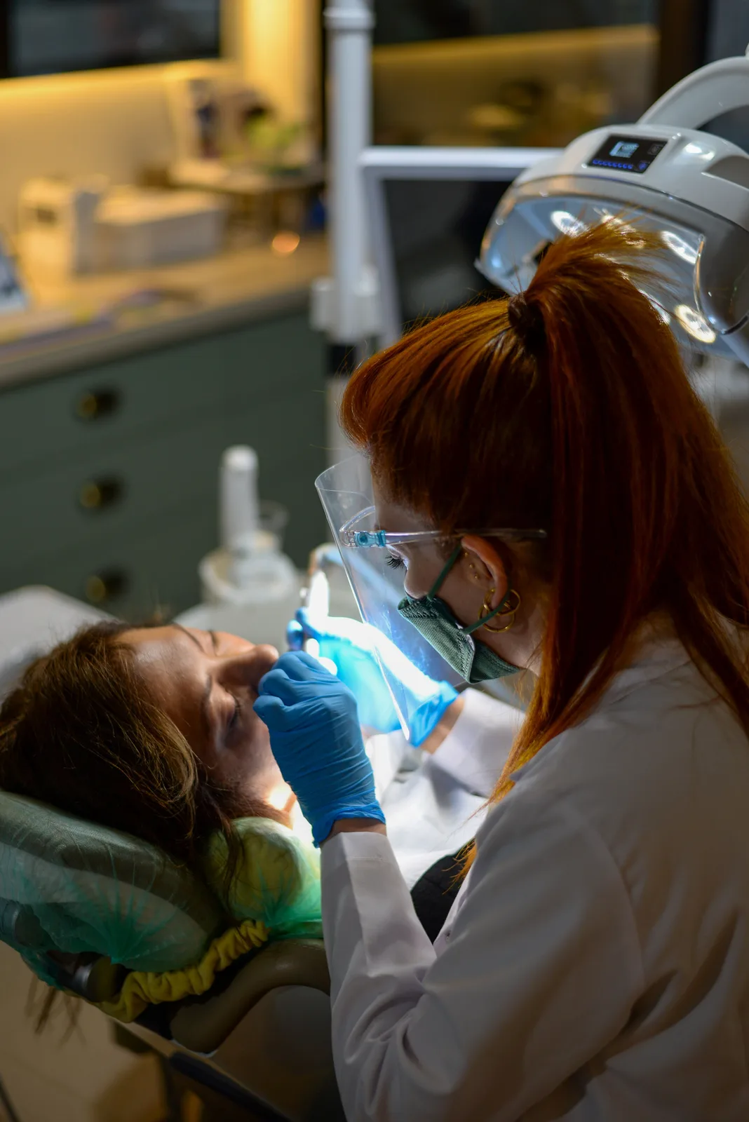 Curing light used during chairside treatment, shown while covering Dental Implant Cost in Winnipeg