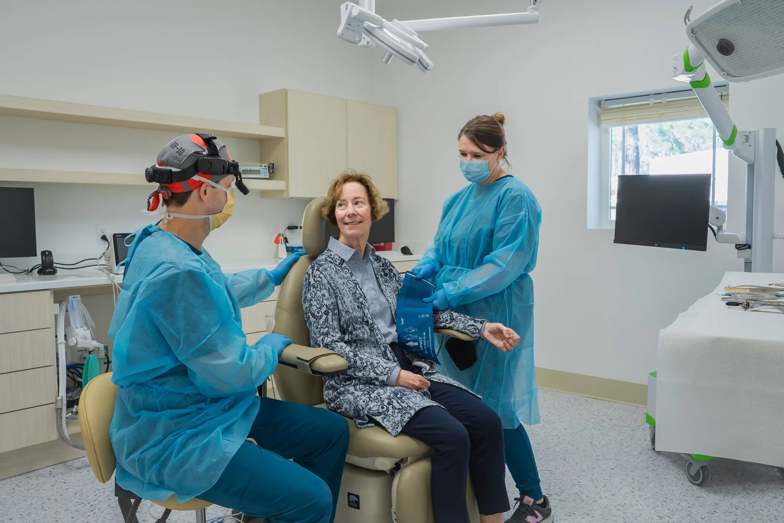 Dental team with a patient in the operatory, shown while covering Socket Preservation in Winnipeg