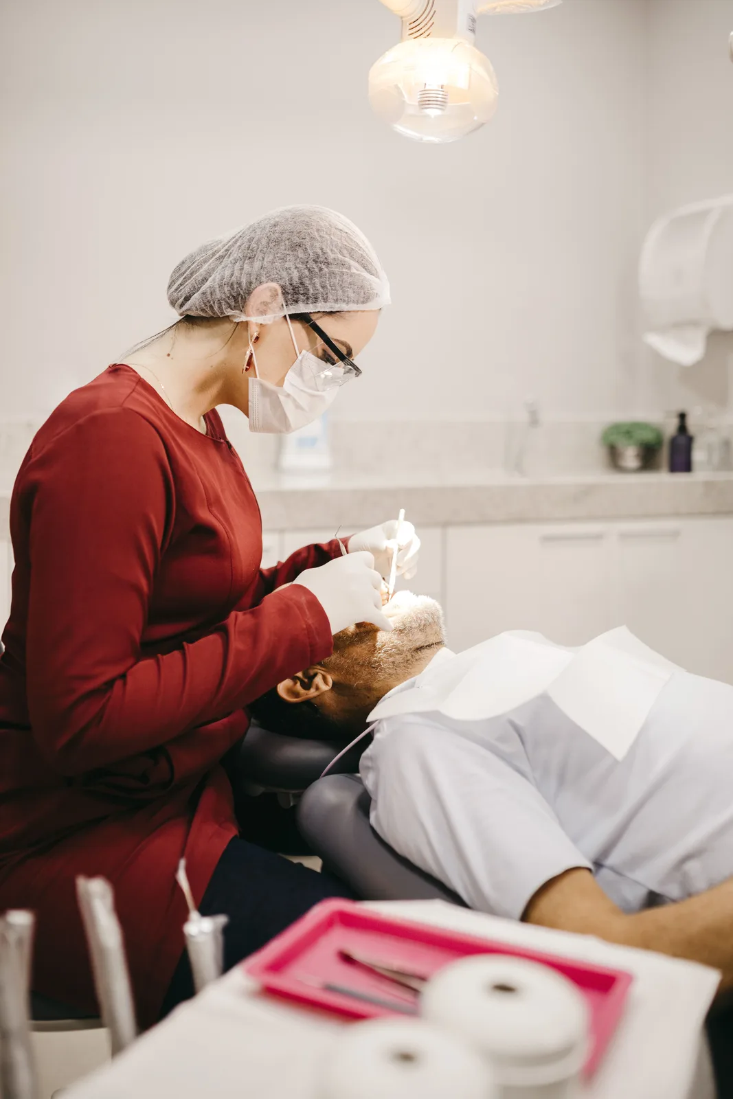Dentist working under the operatory light, referred to in the Implant Procedures section for Winnipeg