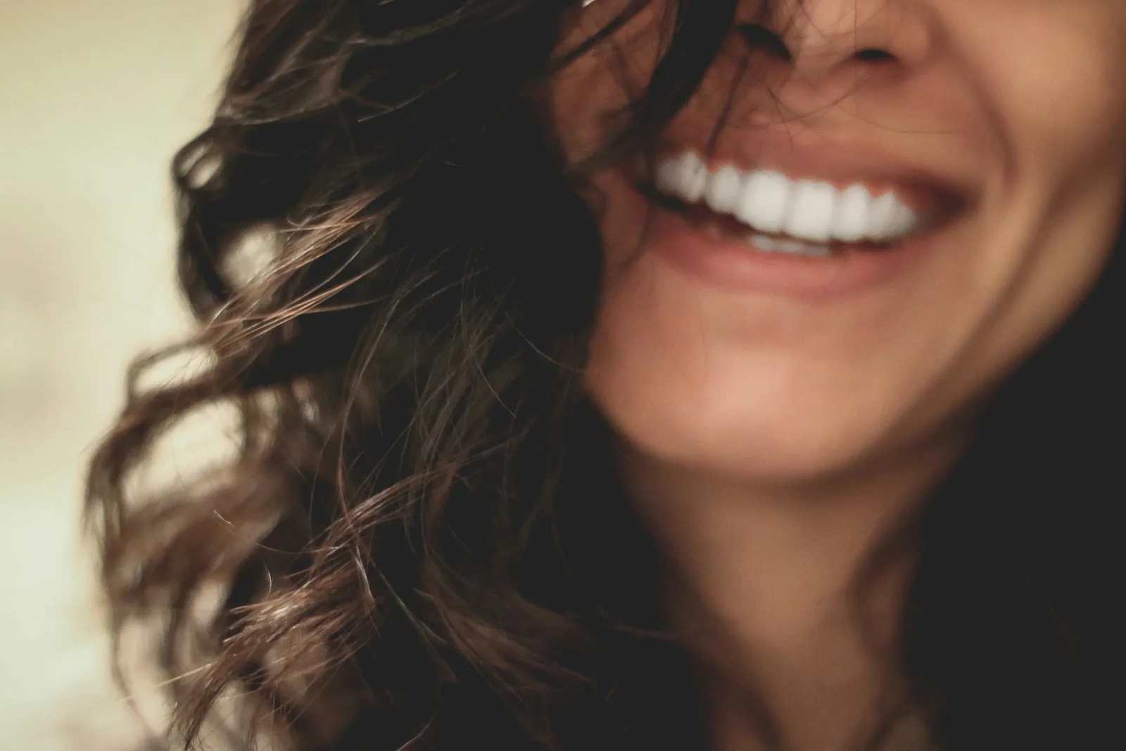 Patient smiling after dental implant treatment, shown while covering Same Day Implants in Winnipeg
