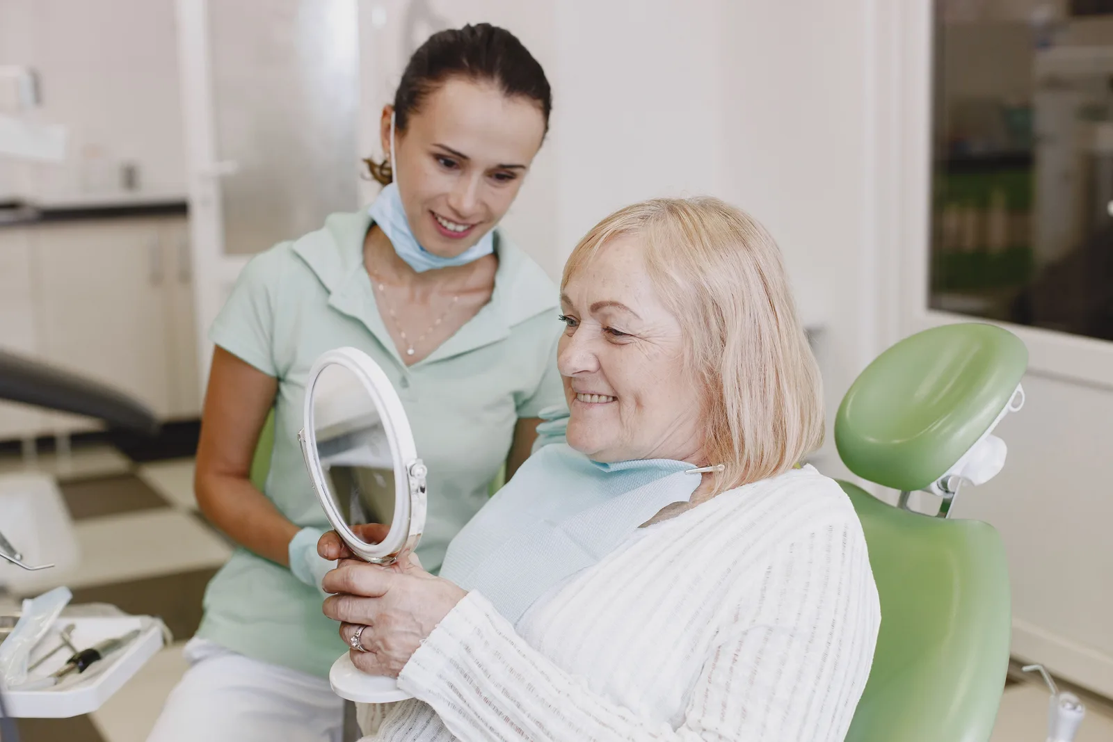 Reviewing the finished smile with the patient, alongside the Implant Lifespan explanation in Winnipeg