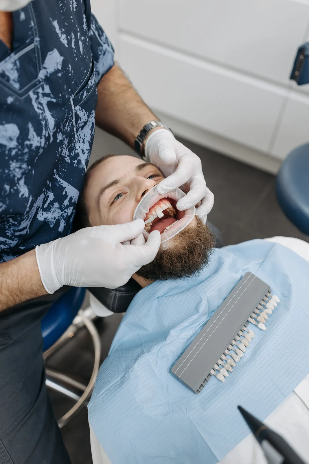 Selecting a crown shade chairside, alongside the Implant Surgery Day explanation in Winnipeg