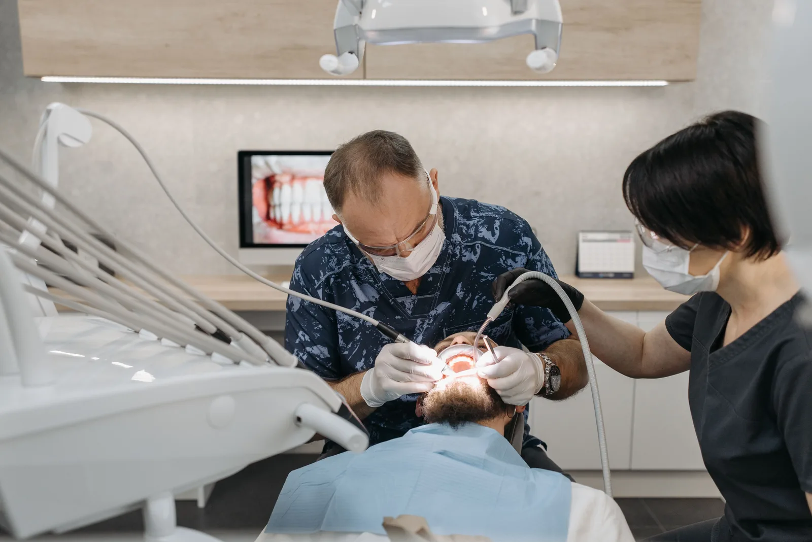 Dentist and assistant working together during treatment, referred to in the All-on-6 Implants section for Winnipeg